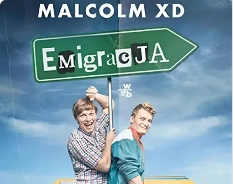 Two smiling men stand in front of a colorful van, holding a large green sign reading "Emigracja." The sky is bright blue with scattered clouds.
